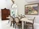 Elegant dining room with neutral colors, large windows, and seating for six guests at 17926 Calkins Ct, Spring Hill, FL 34610
