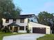 Charming two-story home with a well-manicured lawn, updated garage, and cozy covered entryway at 17926 Calkins Ct, Spring Hill, FL 34610