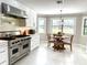 Bright kitchen and eat-in area boasts stainless steel appliances, a big window, and an open floor plan at 17926 Calkins Ct, Spring Hill, FL 34610
