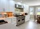 Bright kitchen features white cabinets, stainless steel appliances, and quartz countertops at 17926 Calkins Ct, Spring Hill, FL 34610