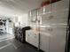Well-equipped laundry room featuring a washer, dryer, ample storage cabinets, and a sink at 17926 Calkins Ct, Spring Hill, FL 34610