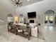 Spacious living room with high ceilings, stone fireplace, and large windows provides ample natural light at 17926 Calkins Ct, Spring Hill, FL 34610