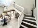 Bright living room with a staircase, wood accents, and stylish decor in an open-concept living space at 17926 Calkins Ct, Spring Hill, FL 34610