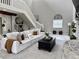 Bright living room features a stone fireplace, high ceilings, and a comfortable white sofa at 17926 Calkins Ct, Spring Hill, FL 34610