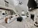 Bright living room features a stone fireplace, high ceilings, and a comfortable white sofa at 17926 Calkins Ct, Spring Hill, FL 34610