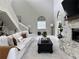 Bright living room features a stone fireplace, high ceilings, and a comfortable white sofa at 17926 Calkins Ct, Spring Hill, FL 34610