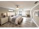 This spacious main bedroom features stylish decor, chandelier lighting, and a comfortable sitting area, creating a serene retreat at 17926 Calkins Ct, Spring Hill, FL 34610