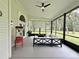 Comfortable outdoor screened patio with a seating area, ceiling fan, and space for entertainment at 17926 Calkins Ct, Spring Hill, FL 34610