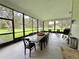 Spacious screened patio featuring a large dining table with seating and a view of the green backyard at 17926 Calkins Ct, Spring Hill, FL 34610