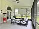 Cozy screened patio with comfortable seating, ceiling fan, outdoor movie screen, and a popcorn machine at 17926 Calkins Ct, Spring Hill, FL 34610