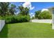 Lush backyard with green grass and a privacy fence for outdoor enjoyment and privacy at 1803 E Powhatan Ave, Tampa, FL 33610