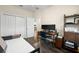 Bedroom with wood-look floors, a built-in desk, and a serene atmosphere at 1803 E Powhatan Ave, Tampa, FL 33610