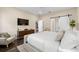 Modern bedroom with a flat screen tv, light color palette, and a sliding barn door at 1803 E Powhatan Ave, Tampa, FL 33610