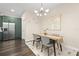 Bright dining area featuring stylish decor, a modern chandelier, and a view into the kitchen at 1803 E Powhatan Ave, Tampa, FL 33610