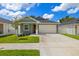 Charming single-story home with a two-car garage, and well-maintained front yard at 1803 E Powhatan Ave, Tampa, FL 33610