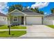 Charming one-story home with a well-manicured lawn, a two-car garage and appealing landscaping at 1803 E Powhatan Ave, Tampa, FL 33610