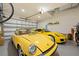 Spacious garage featuring two yellow cars and overhead storage providing functionality at 1803 E Powhatan Ave, Tampa, FL 33610