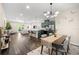 Open-concept living room and kitchen with modern furnishings, a dining area, and sleek, dark-wood floors at 1803 E Powhatan Ave, Tampa, FL 33610