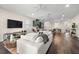 Spacious living room showcasing an open floor plan, modern furnishings, and views into the kitchen and dining area at 1803 E Powhatan Ave, Tampa, FL 33610