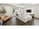 Bright and open living room featuring a plush white sofa, dark-wood floors, and French doors to the outside at 1803 E Powhatan Ave, Tampa, FL 33610