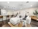 Open-concept living room with modern furnishings, a large sectional sofa, and a view into the kitchen and breakfast bar at 1803 E Powhatan Ave, Tampa, FL 33610