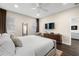 Bright and spacious main bedroom featuring a large window, wooden floors, and an ensuite bathroom at 1803 E Powhatan Ave, Tampa, FL 33610