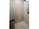 Modern glass-enclosed shower with stylish tile, a shower bench, and modern fixtures at 1803 E Powhatan Ave, Tampa, FL 33610