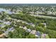 Expansive aerial view of a neighborhood with lush greenery, a serene lake, and neatly arranged homes at 2009 Raven Manor Dr, Dover, FL 33527