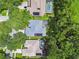 Aerial view showcasing pools and solar panels on roofs nestled amongst lush, mature landscaping at 2009 Raven Manor Dr, Dover, FL 33527