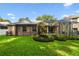 Private backyard with a screened-in pool, well-maintained lawn, and attractive landscaping at 2009 Raven Manor Dr, Dover, FL 33527