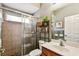 Cozy bathroom featuring a glass-enclosed shower, a single sink vanity, and stylish decorative accents at 2009 Raven Manor Dr, Dover, FL 33527