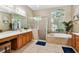 Bright bathroom with a soaking tub, walk-in shower, and double vanity sinks at 2009 Raven Manor Dr, Dover, FL 33527