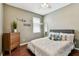 Well-lit bedroom featuring a ceiling fan, dresser and wood-look flooring at 2009 Raven Manor Dr, Dover, FL 33527