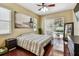Comfortable bedroom with hardwood floors, large bed, and sliding glass doors to the pool area at 2009 Raven Manor Dr, Dover, FL 33527