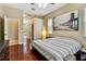 Spacious main bedroom with beautiful flooring, fan and a door leading to the main bathroom at 2009 Raven Manor Dr, Dover, FL 33527