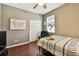 Neutral bedroom features a ceiling fan, closet and wood-look flooring at 2009 Raven Manor Dr, Dover, FL 33527