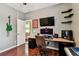 Bedroom featuring a wooden desk, large monitor, keyboard, and ample workspace for work or gaming at 2009 Raven Manor Dr, Dover, FL 33527