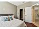 Bright bedroom with closet, and view to ensuite bathroom; features wood-look floors at 2009 Raven Manor Dr, Dover, FL 33527