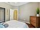 Well-lit bedroom features a closet, dresser and wood-look flooring at 2009 Raven Manor Dr, Dover, FL 33527
