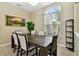Elegant dining area with a large window and a rustic wooden table set for six at 2009 Raven Manor Dr, Dover, FL 33527