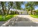 Beautiful home with an attached two-car garage, lush lawn, and mature landscaping at 2009 Raven Manor Dr, Dover, FL 33527