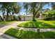 Landscaped front lawn leading up to a two-car attached garage provides an appealing curb appeal at 2009 Raven Manor Dr, Dover, FL 33527