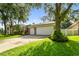 Lush landscaping and large trees accentuate this home with an attached two-car garage at 2009 Raven Manor Dr, Dover, FL 33527