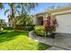 Beautifully landscaped front entrance with an arched entryway welcomes you home at 2009 Raven Manor Dr, Dover, FL 33527