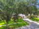 Charming single-story home with lush landscaping, mature trees and a well-manicured lawn at 2009 Raven Manor Dr, Dover, FL 33527