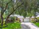 Beautiful single-story home with lush landscaping, mature trees and a spacious driveway at 2009 Raven Manor Dr, Dover, FL 33527