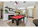 Spacious game room featuring a pool table, stylish shelving, and an open view of the front entry at 2009 Raven Manor Dr, Dover, FL 33527