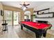 This game room features a pool table, bar table and chair, and sliding door access to the lanai at 2009 Raven Manor Dr, Dover, FL 33527