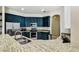Stylish kitchen featuring navy blue cabinets, granite countertops, and stainless steel appliances at 2009 Raven Manor Dr, Dover, FL 33527