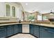 Open kitchen with blue and white cabinets, granite countertops, and a stainless steel dishwasher at 2009 Raven Manor Dr, Dover, FL 33527